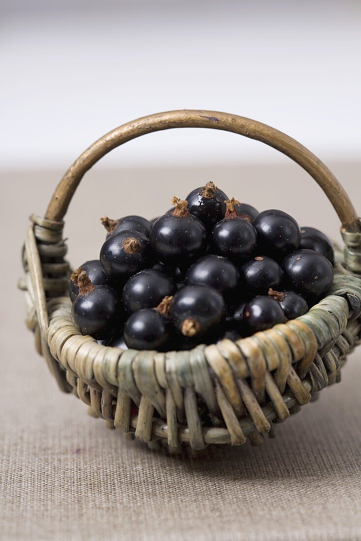 Blackcurrants in a small wicker basket