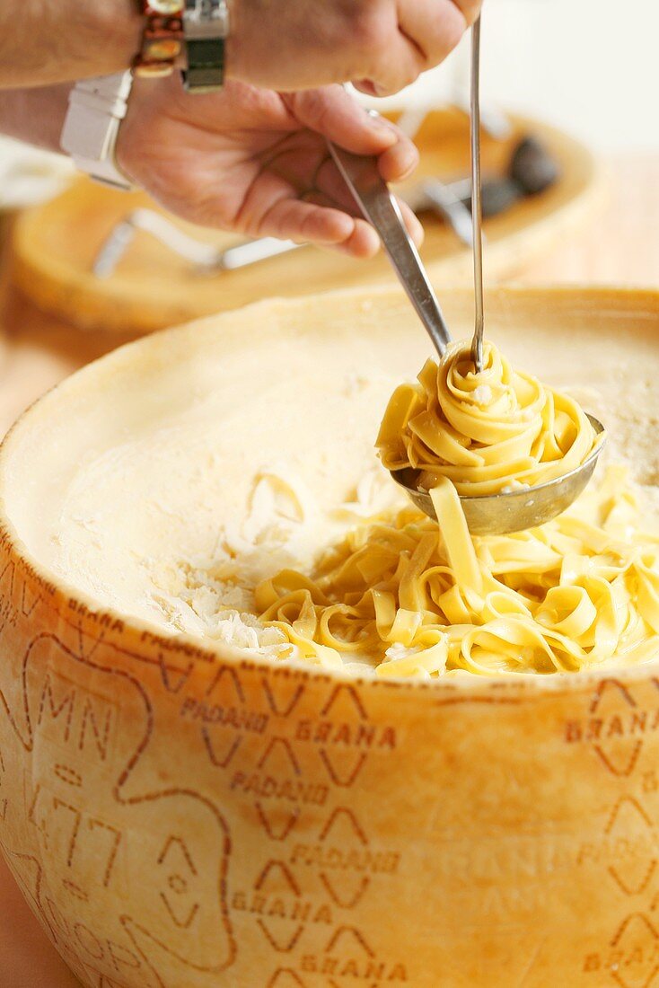 Ribbon pasta with Grana Padano cheese – License Images – 800432 ❘ StockFood