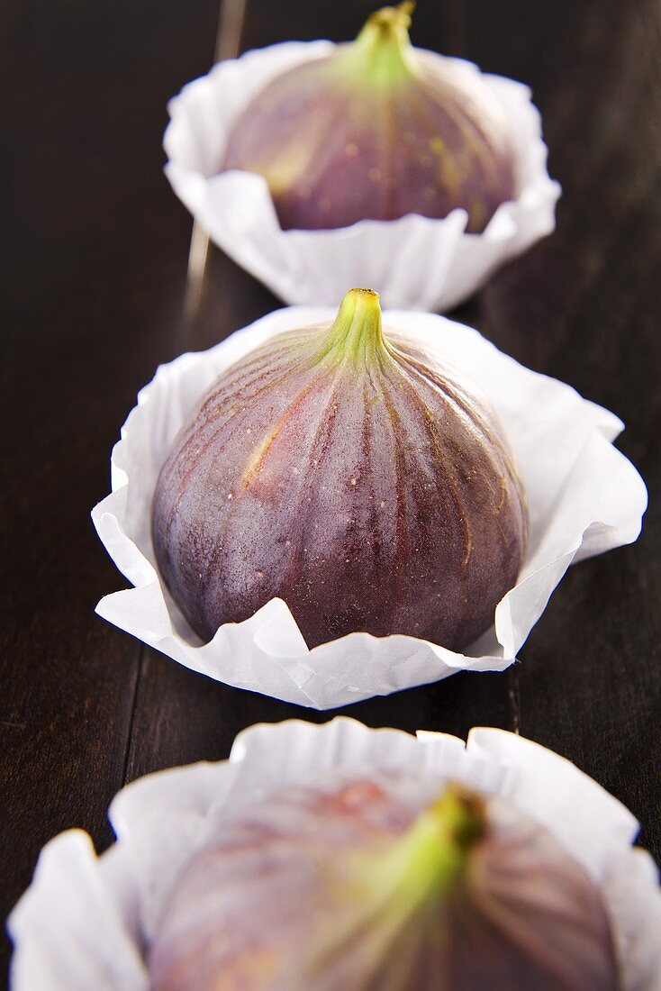 Three figs in paper cases