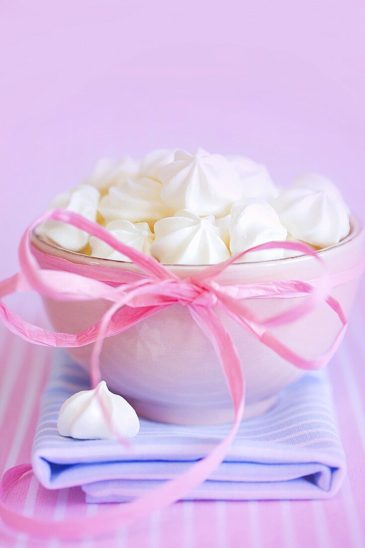 Meringues in a bowl with a bow