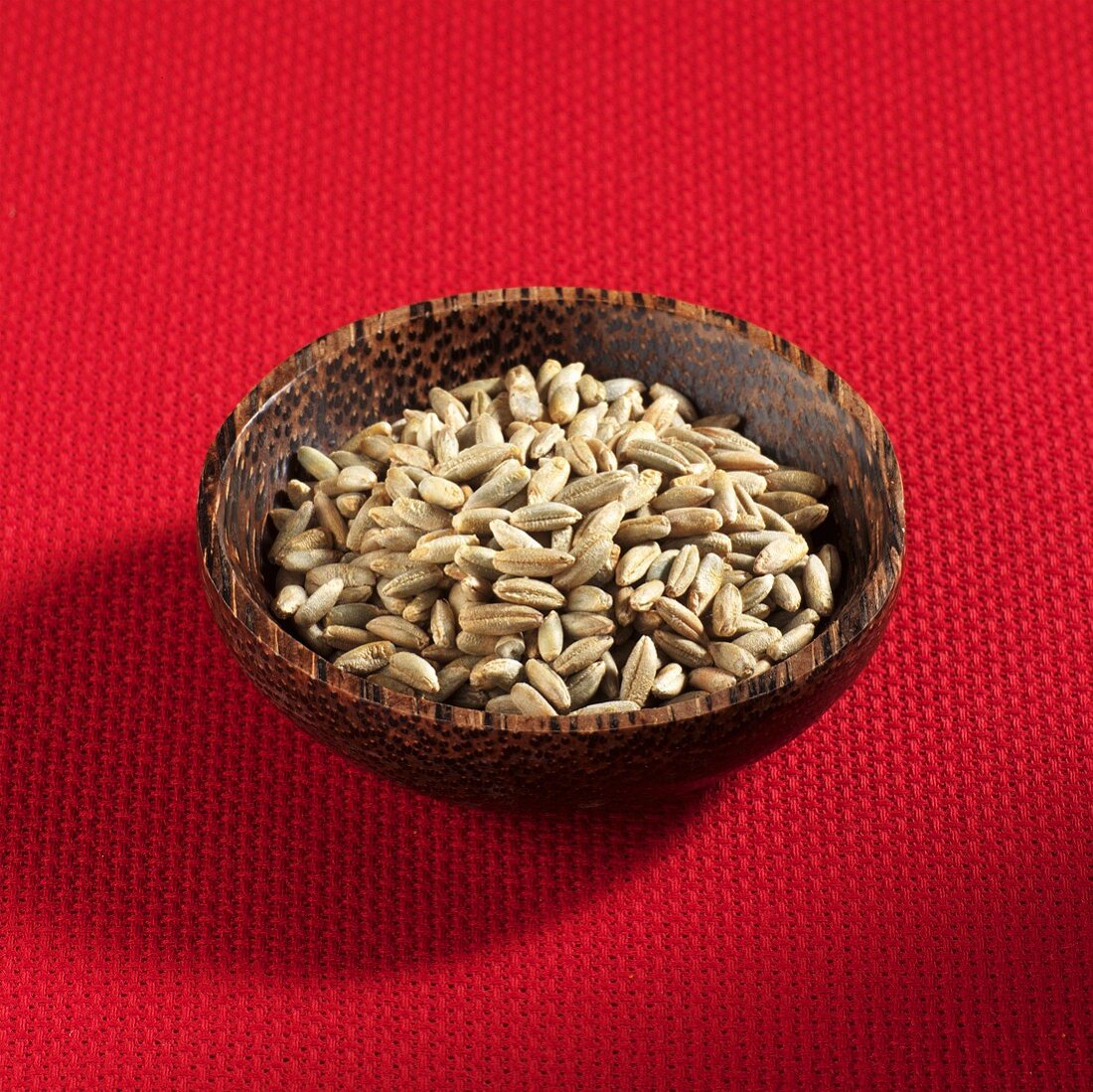 Grains of rye in wooden bowl