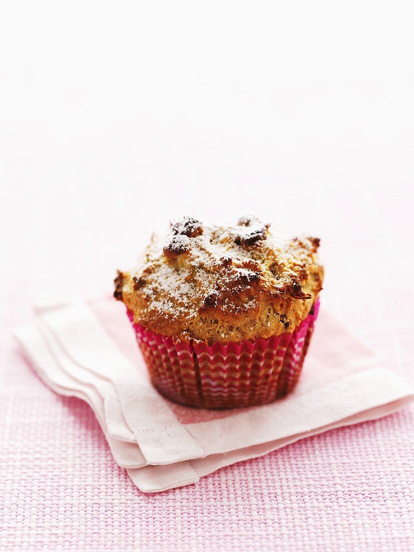 Apple and cranberry muffin with icing sugar