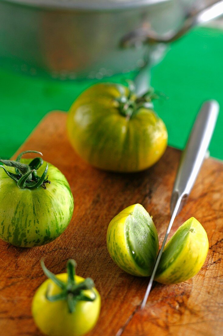 Green tomatoes on a chopping board