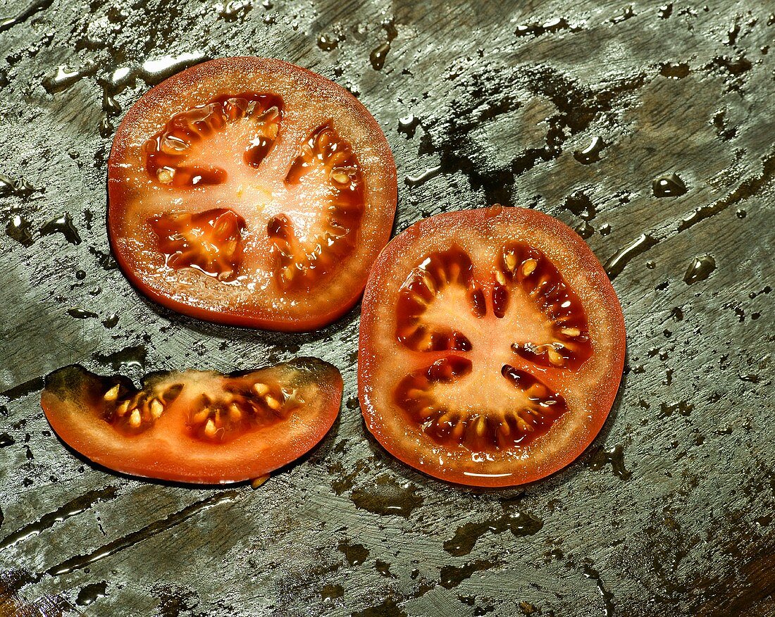 Slices of tomato on a wooden surface