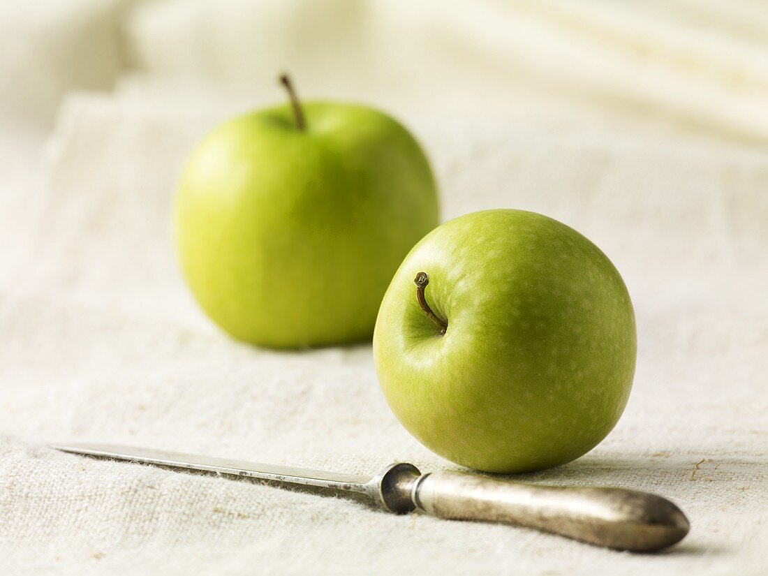 Two green apples and a knife