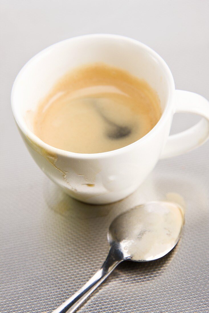A cup of espresso with a spoon