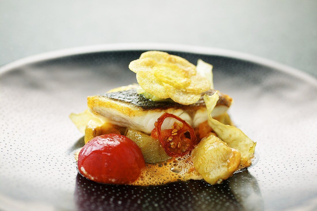 Bass fillet with artichokes and tomatoes