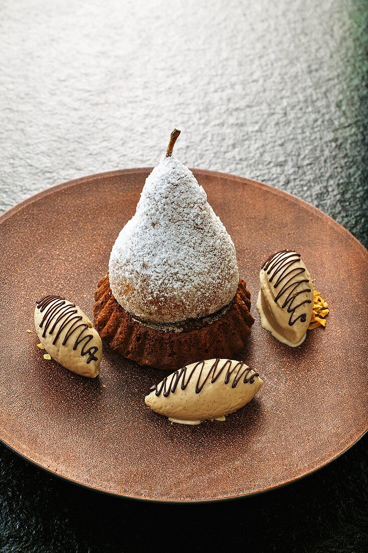 A baked pear on a chocolate cake with nougat ice cream