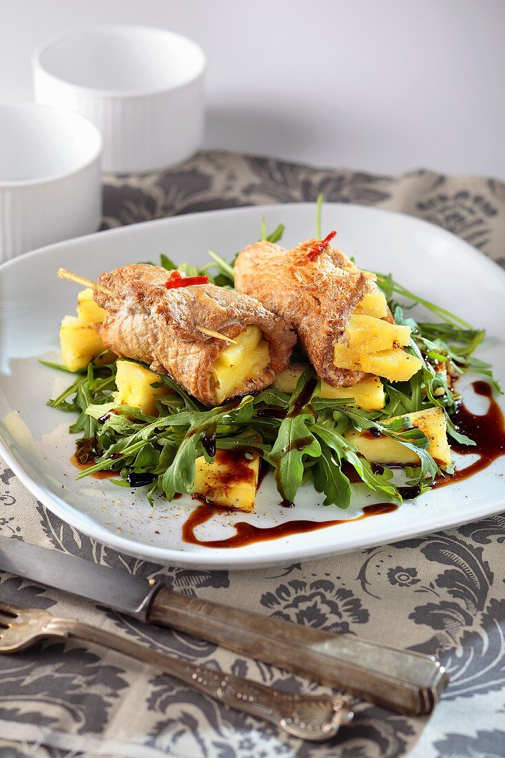Pork loin with a pineapple filling on a bed of rocket