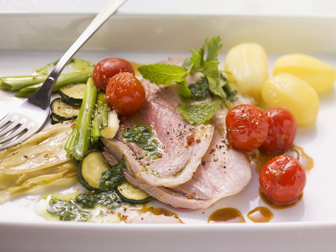 Roast leg of lamb with herb pesto and vegetables