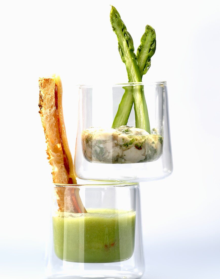 Cream of asparagus soup with a bread stick