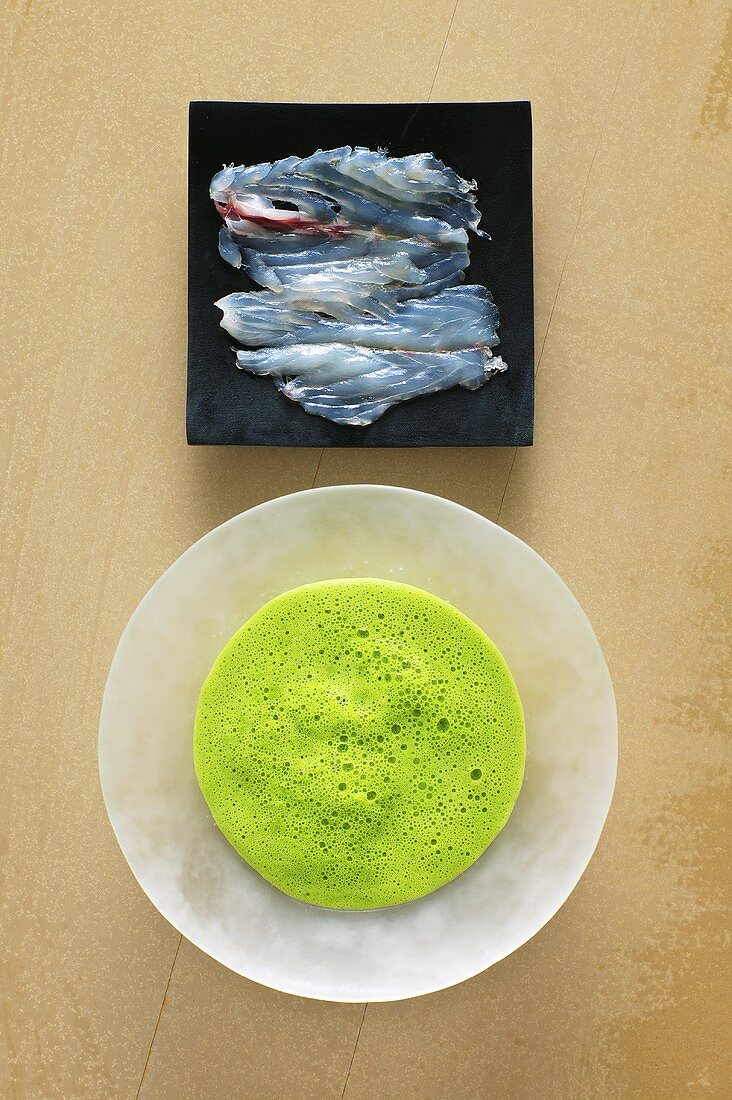 Parsley foam soup with marinated sea bass