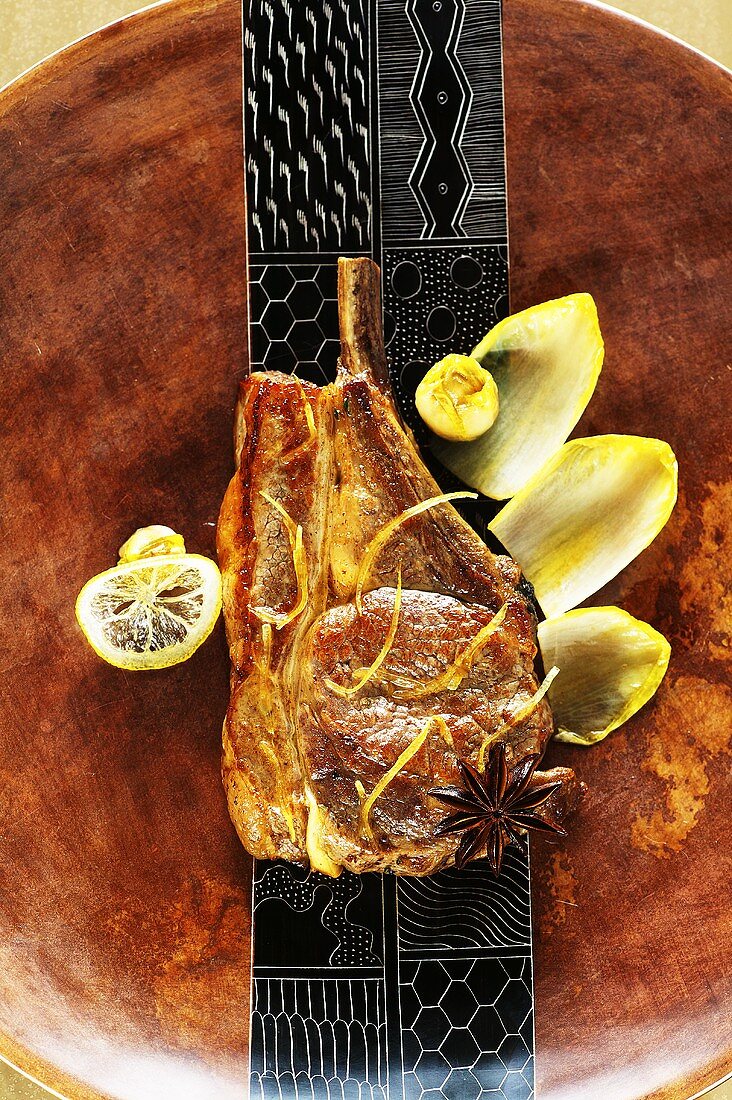 Veal chop with chicory and lemon confit