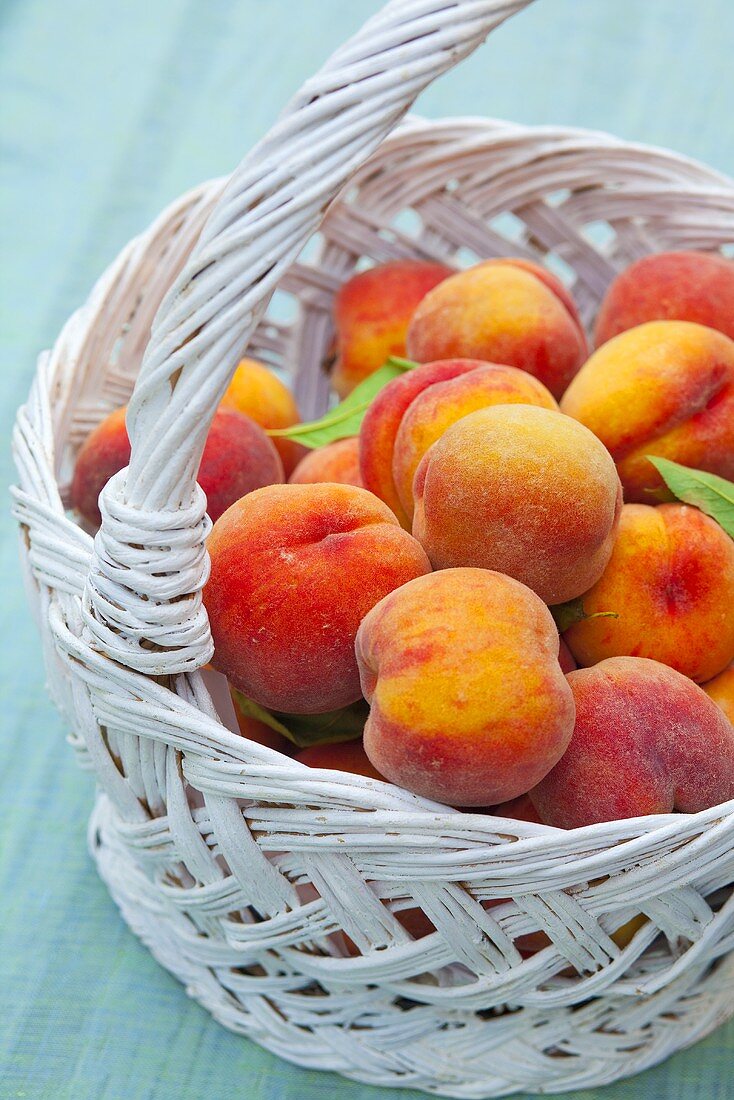 Lots of fresh peaches in a basket