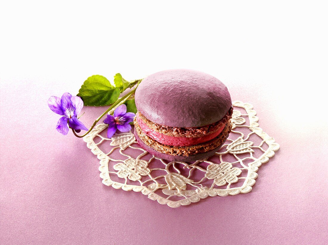 Macaroon with violets on a doily