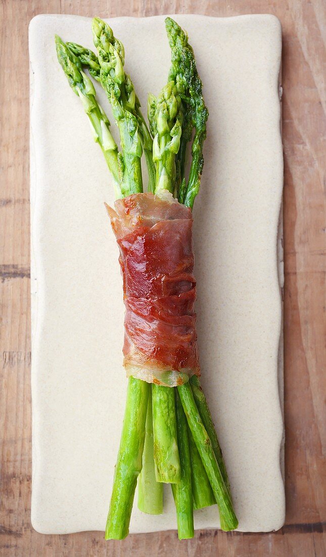Roasted green asparagus wrapped in parma ham