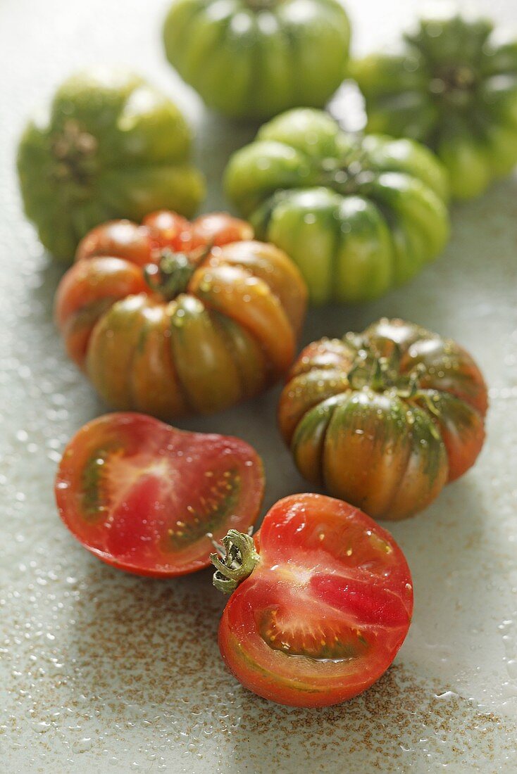 Rote und grüne Fleischtomaten mit Wassertropfen