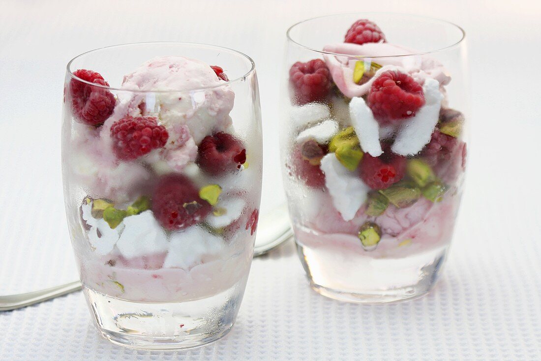 Ice cream sundaes with raspberries and pistachios