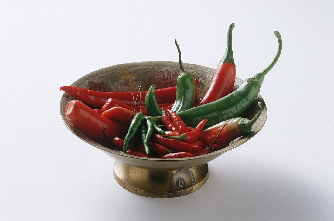 Red and Green Chili Peppers in Brass Bowl