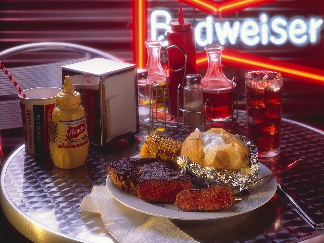 Steak and Baked Potato with Corn in a Diner