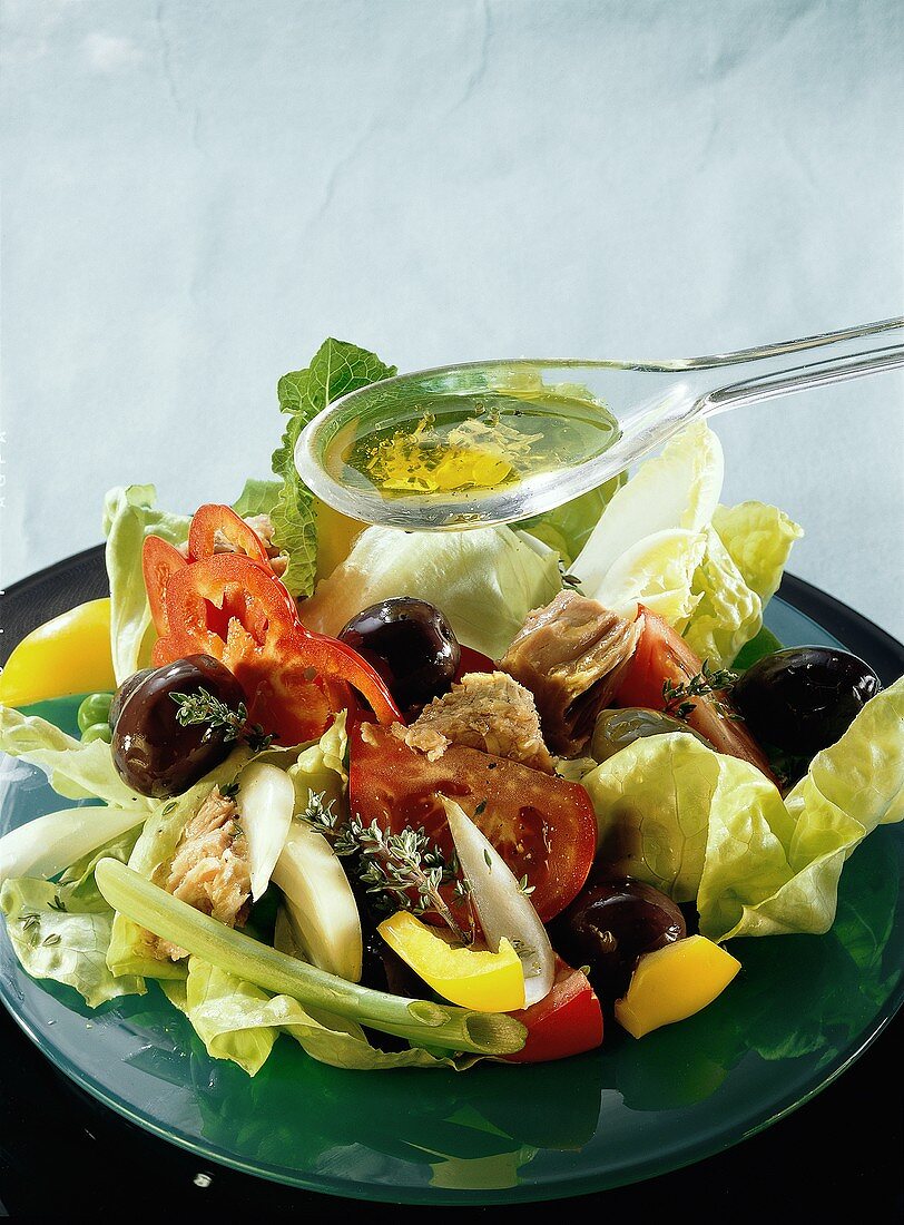 Tuna Salad with Spoon of Salad Dressing; Salad Nicoise