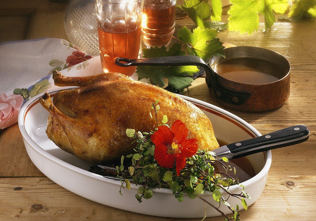 Roast duck with herb stuffing on a wooden table