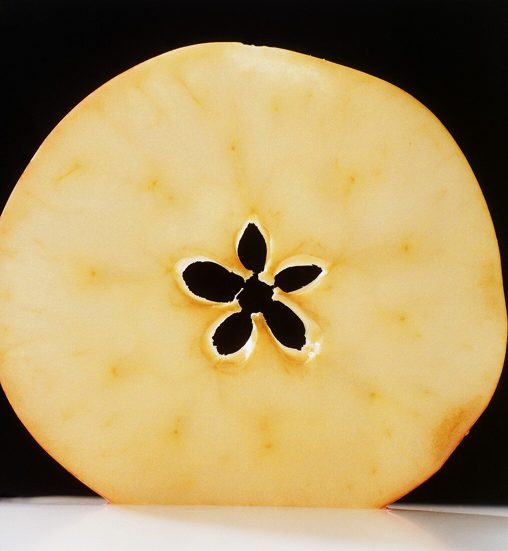 A slice of apple against a black background