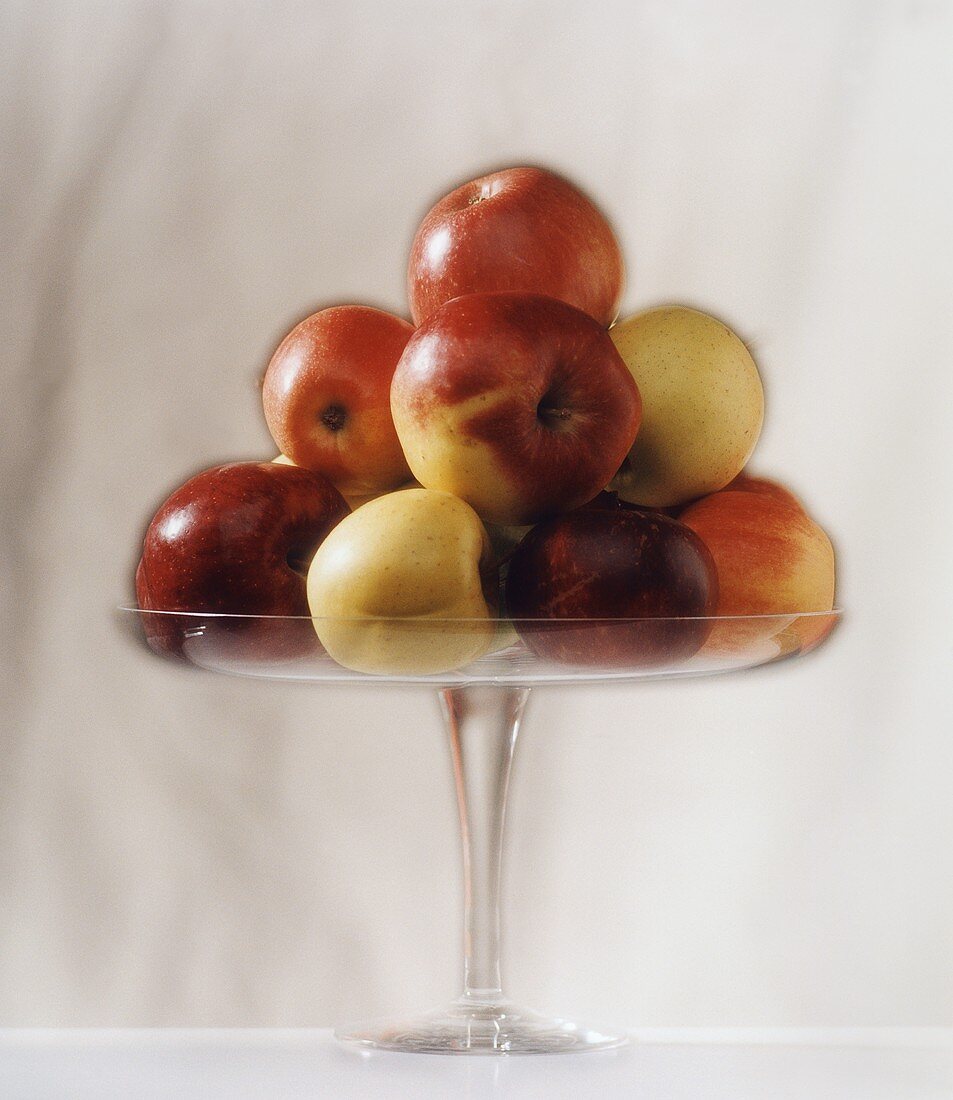 Several apples piled up in a fruit bowl