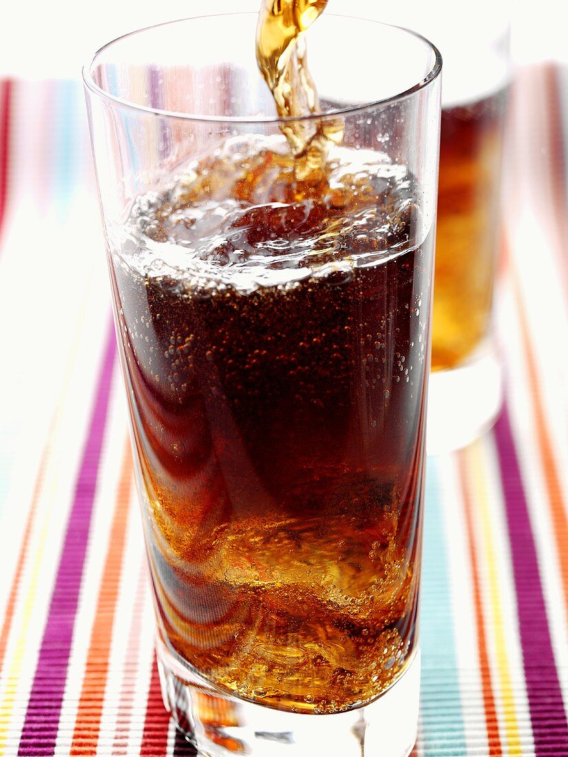 Cola being poured into a glass