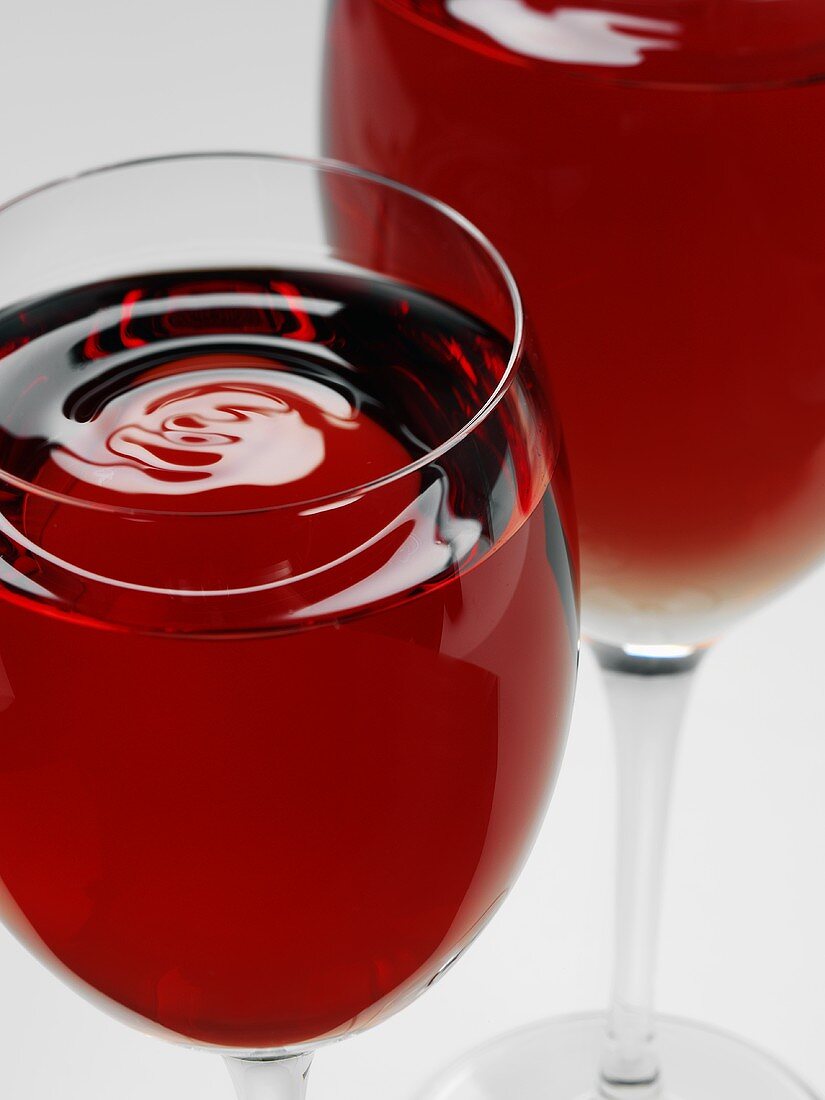 Two glasses of red wine with rippled surface