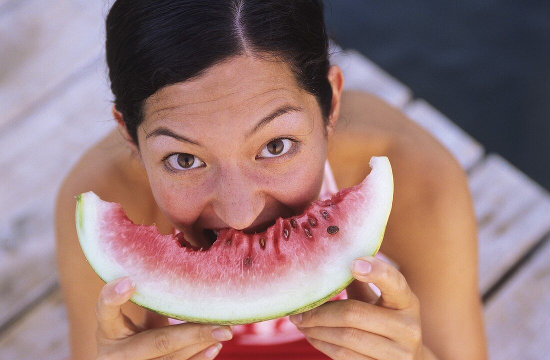 Young woman eating watermelon