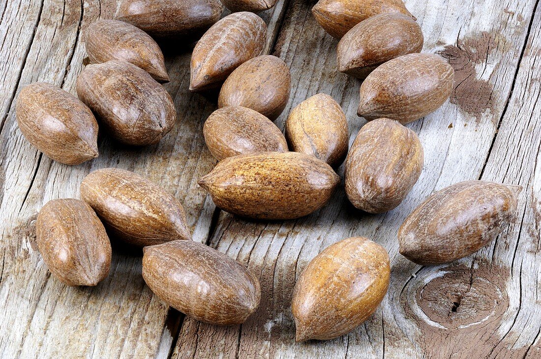 Several pecans on wooden background