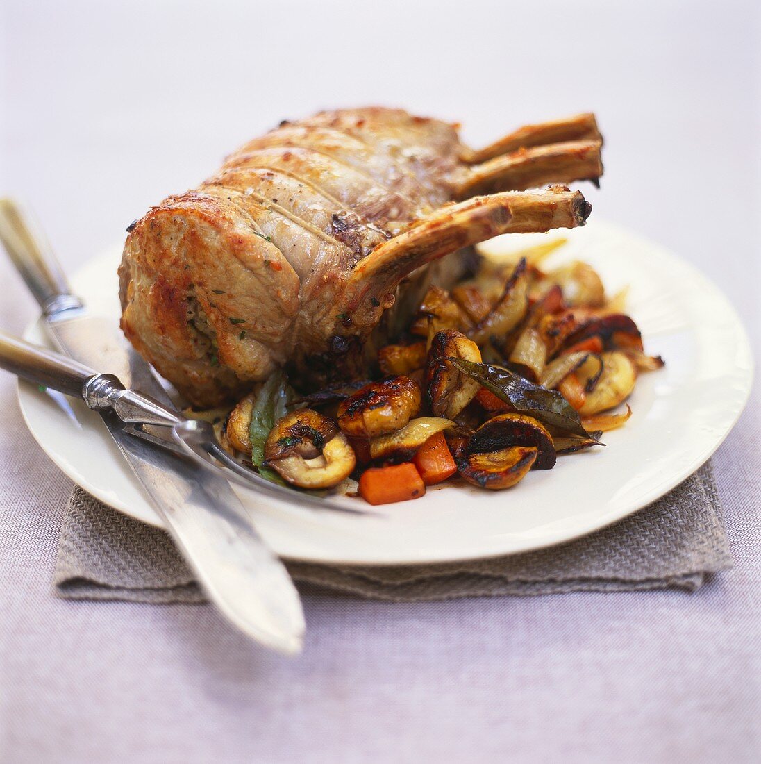 Stuffed roast pork with chestnuts, carrots and bay leaf