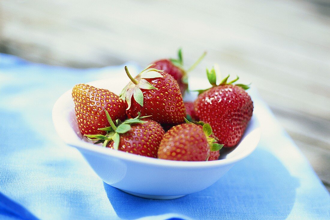 Fresh strawberries in white bowl