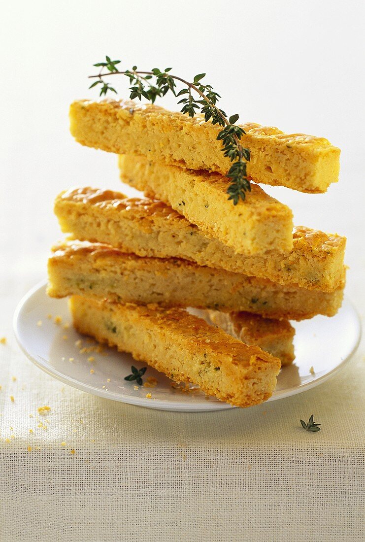 Cheese fingers with thyme, in a pile on plate