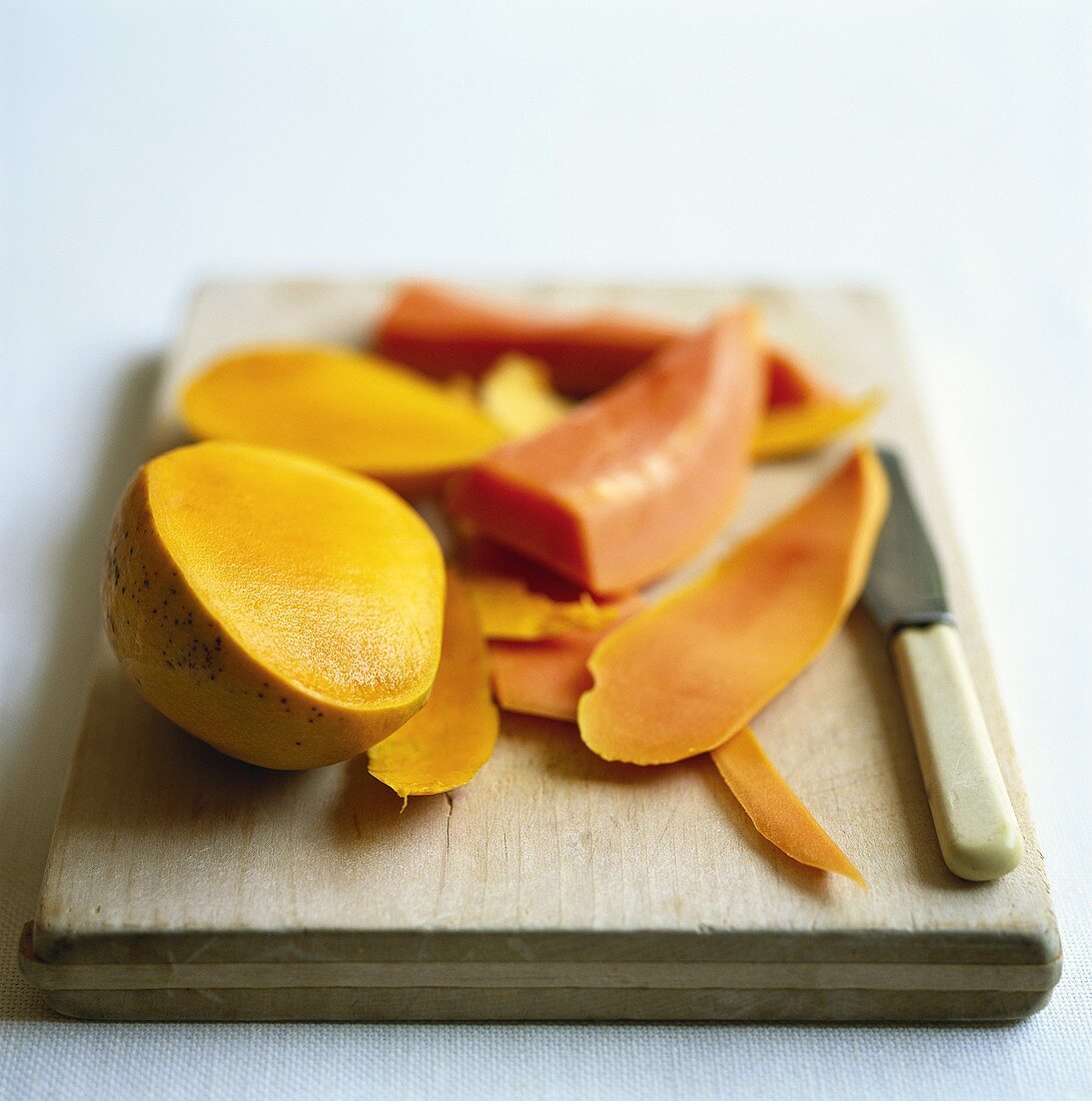 Mango, cut up on chopping board