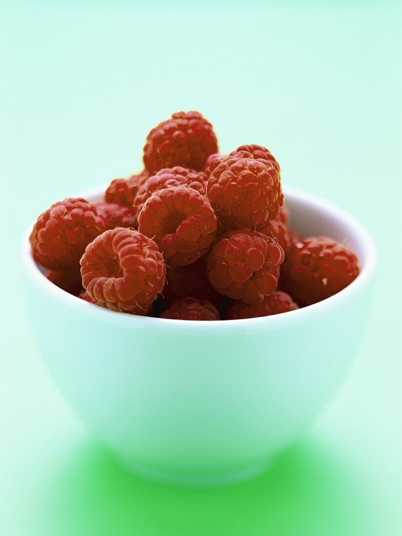 Fresh raspberries in white bowl