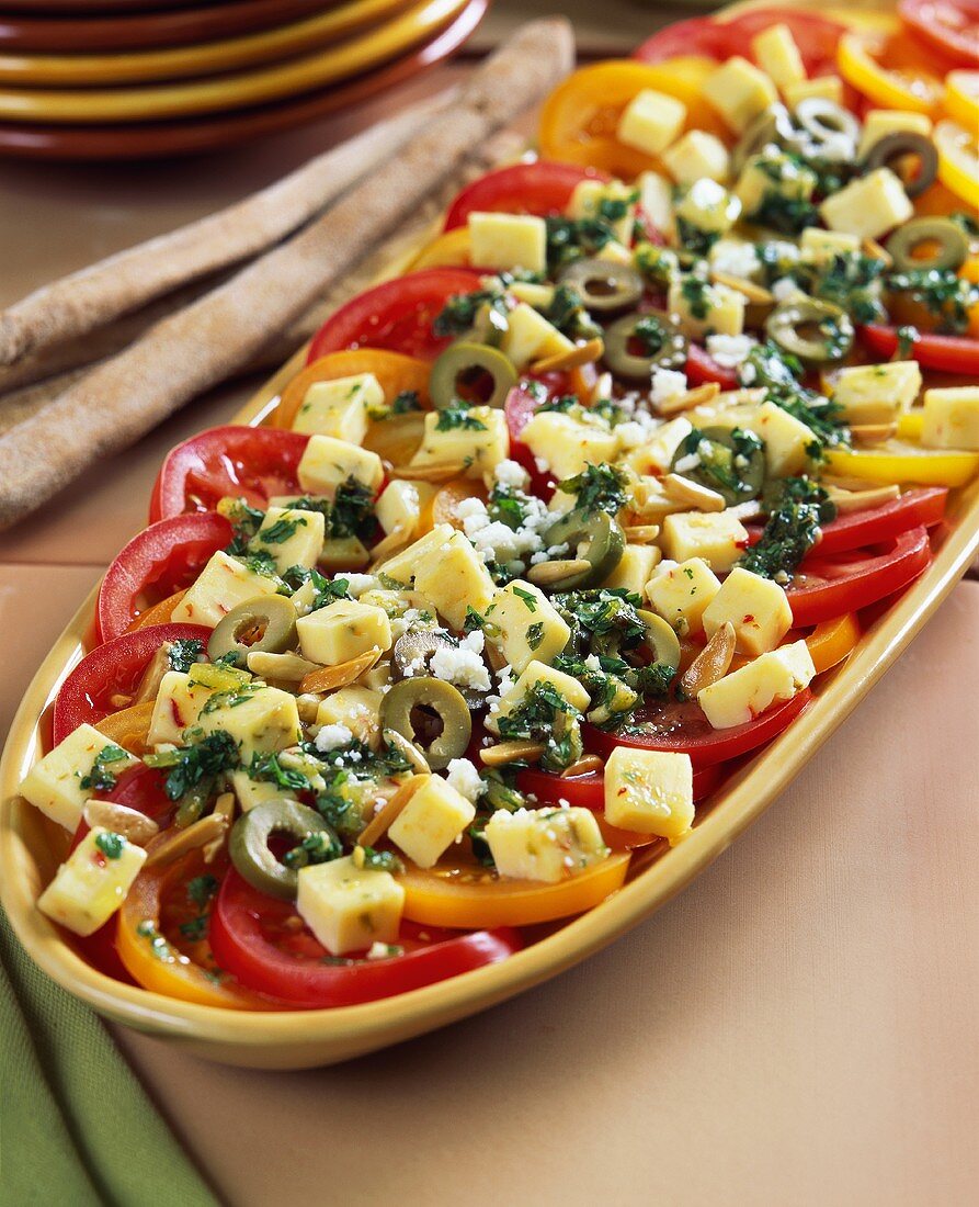 Tomato salad with cheese, olives and pine nuts (Mexico)