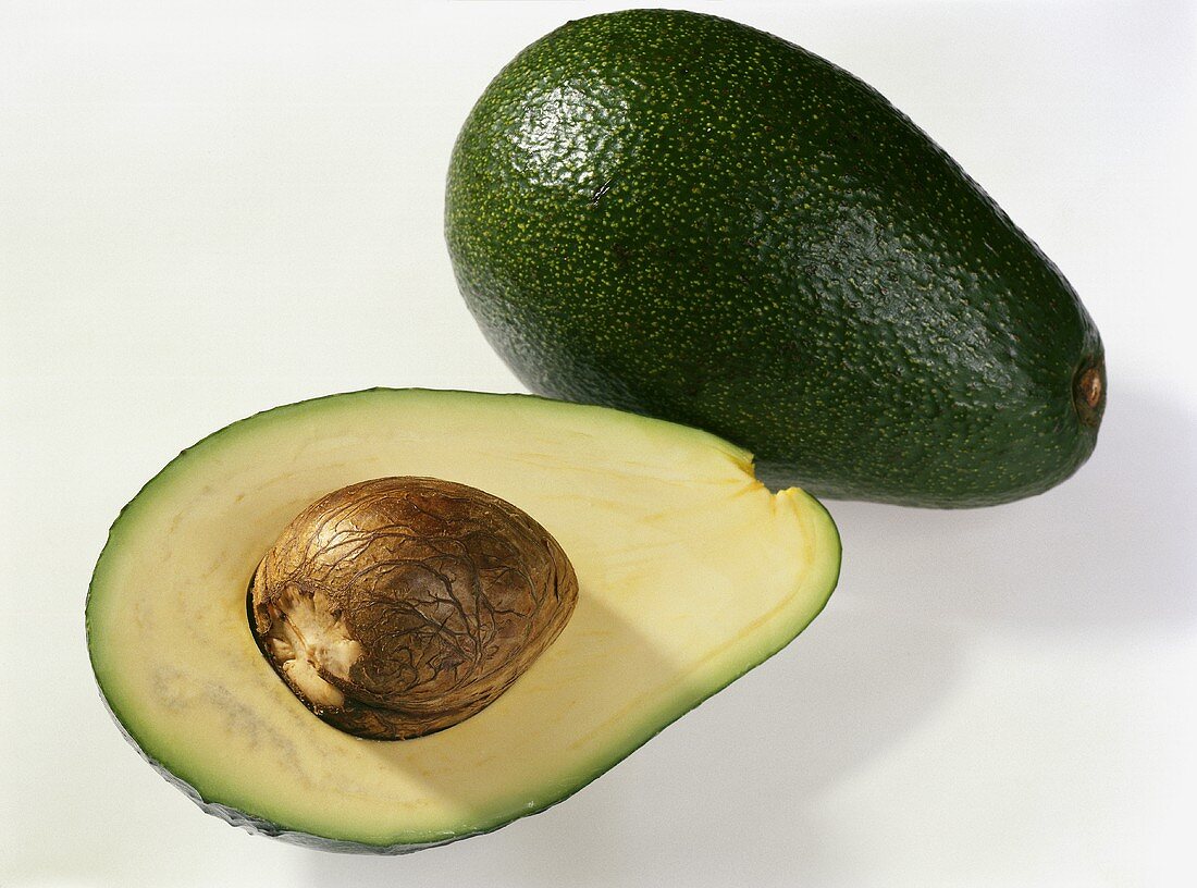 Avocado, variety: Fuerte (Persea americana) halved, with stone