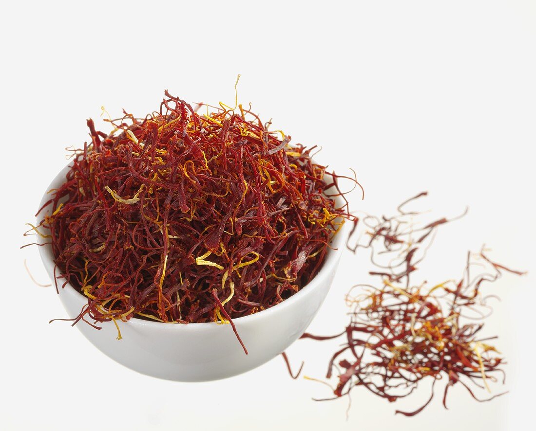 Saffron threads in and beside small bowl