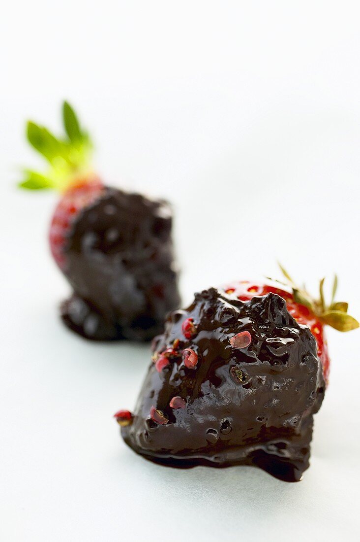 Two strawberries with chocolate sauce