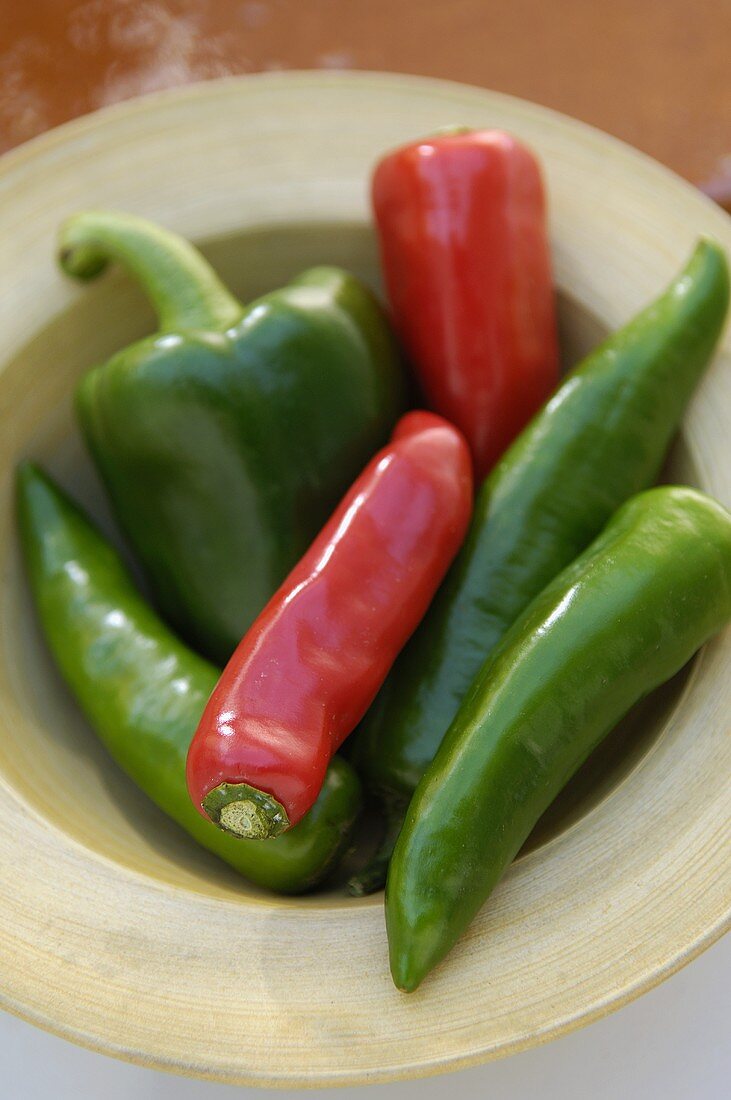 Red and green chili peppers on plate