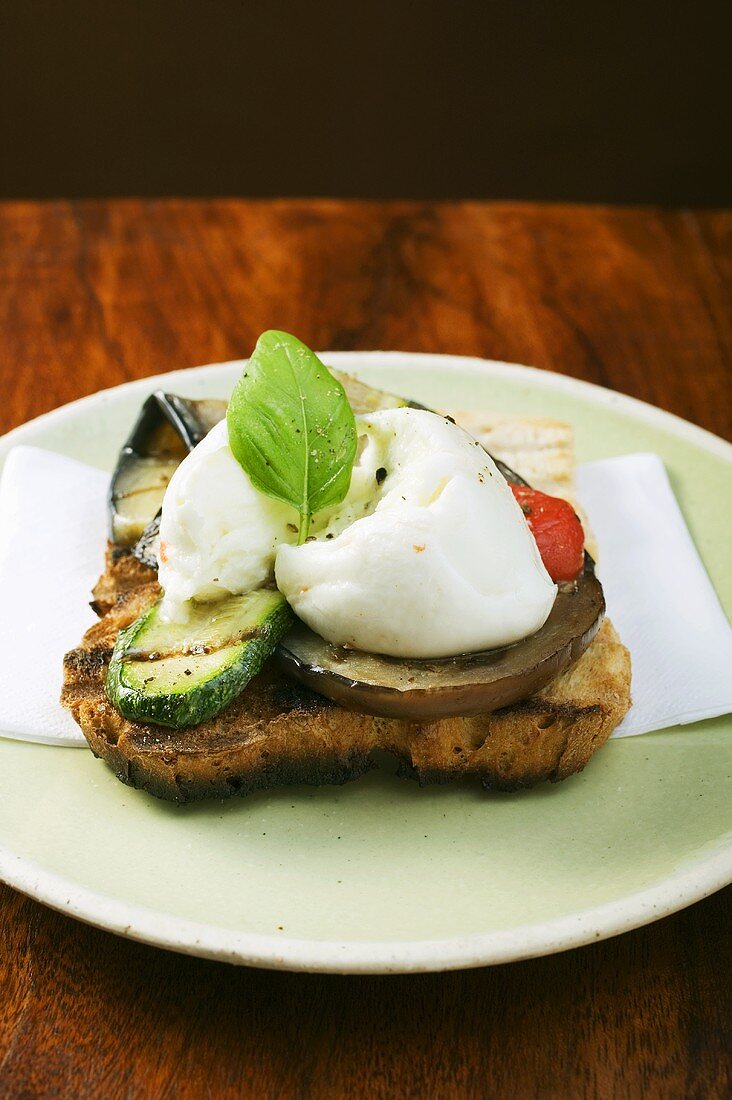 Grilled vegetables, mozzarella and basil on toast