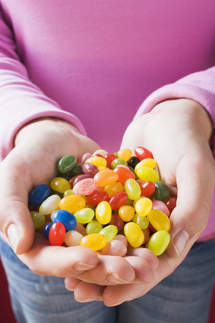 Hands holding coloured jelly beans