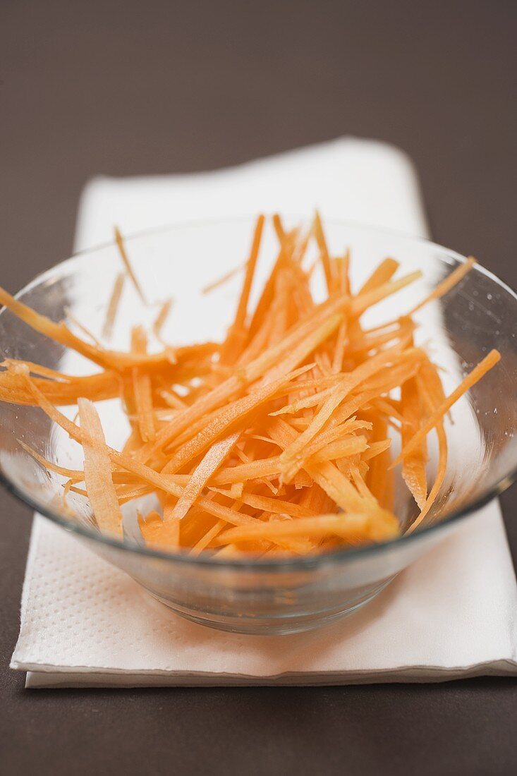Grated carrot in glass bowl