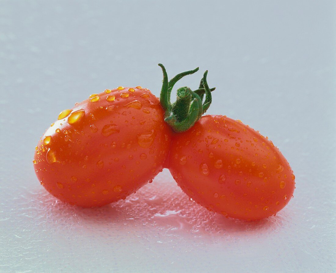 Twin tomatoes with drops of water