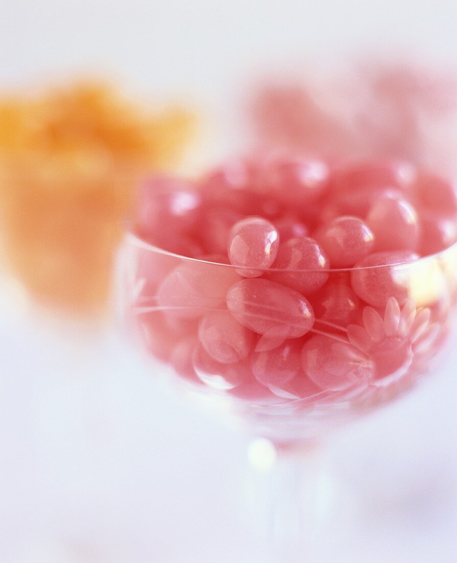 Pink jelly beans in a glass