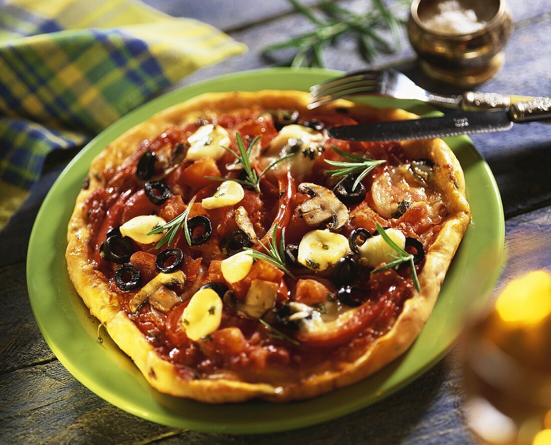 Tomato and mushroom pizza with olives