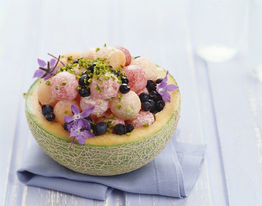 Stuffed melon with pistachios and borage flowers