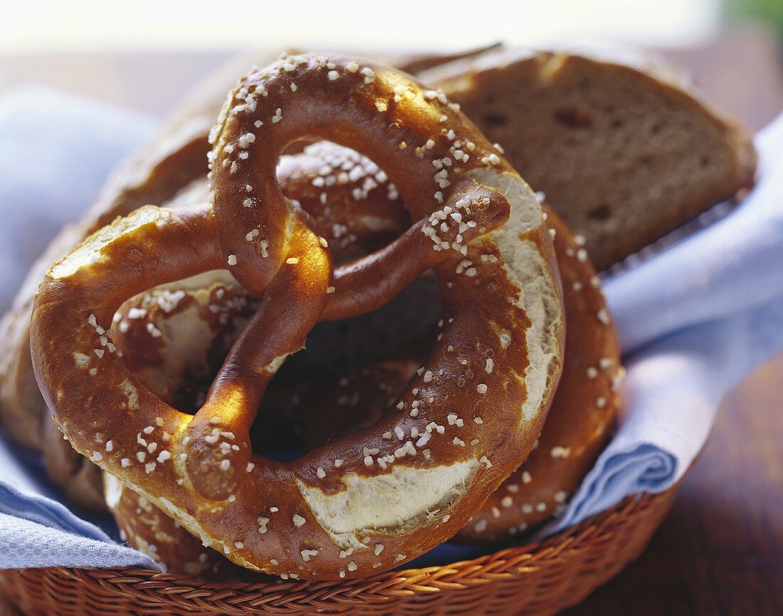 Soft pretzels and slices of bread in a bread basket